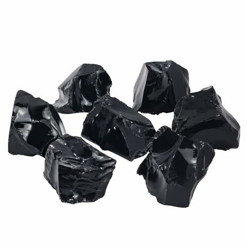 Svarta obsidianstenar på vit bakgrund.