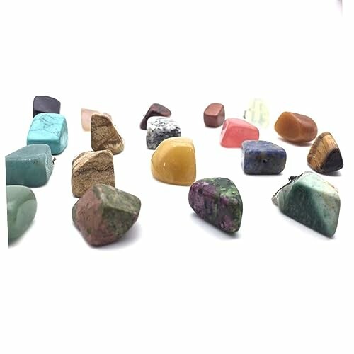 Flera färgglada polerade stenar på vit bakgrund.