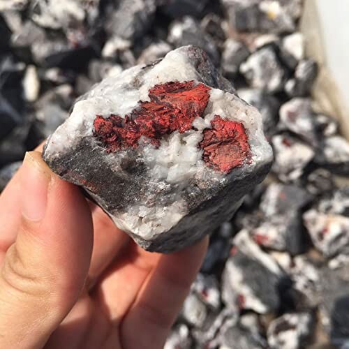 Rå hematit med röd färg i handen.