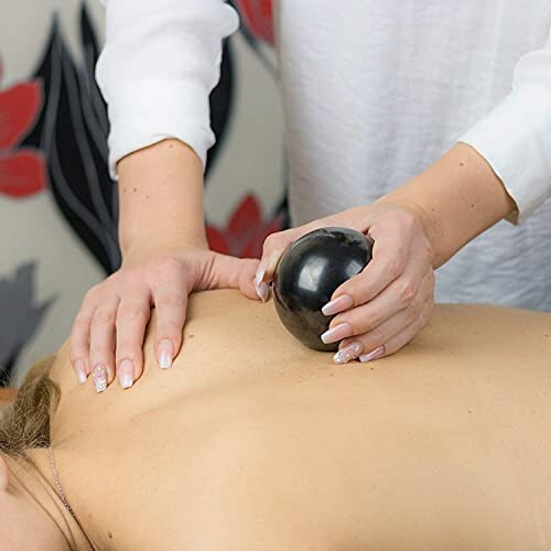 Massage med svart boll på rygg