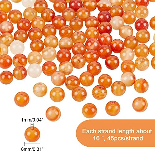 Orange och vita agatpärlor i olika storlekar