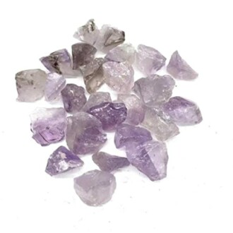 Råa ametistkristaller på vit bakgrund.